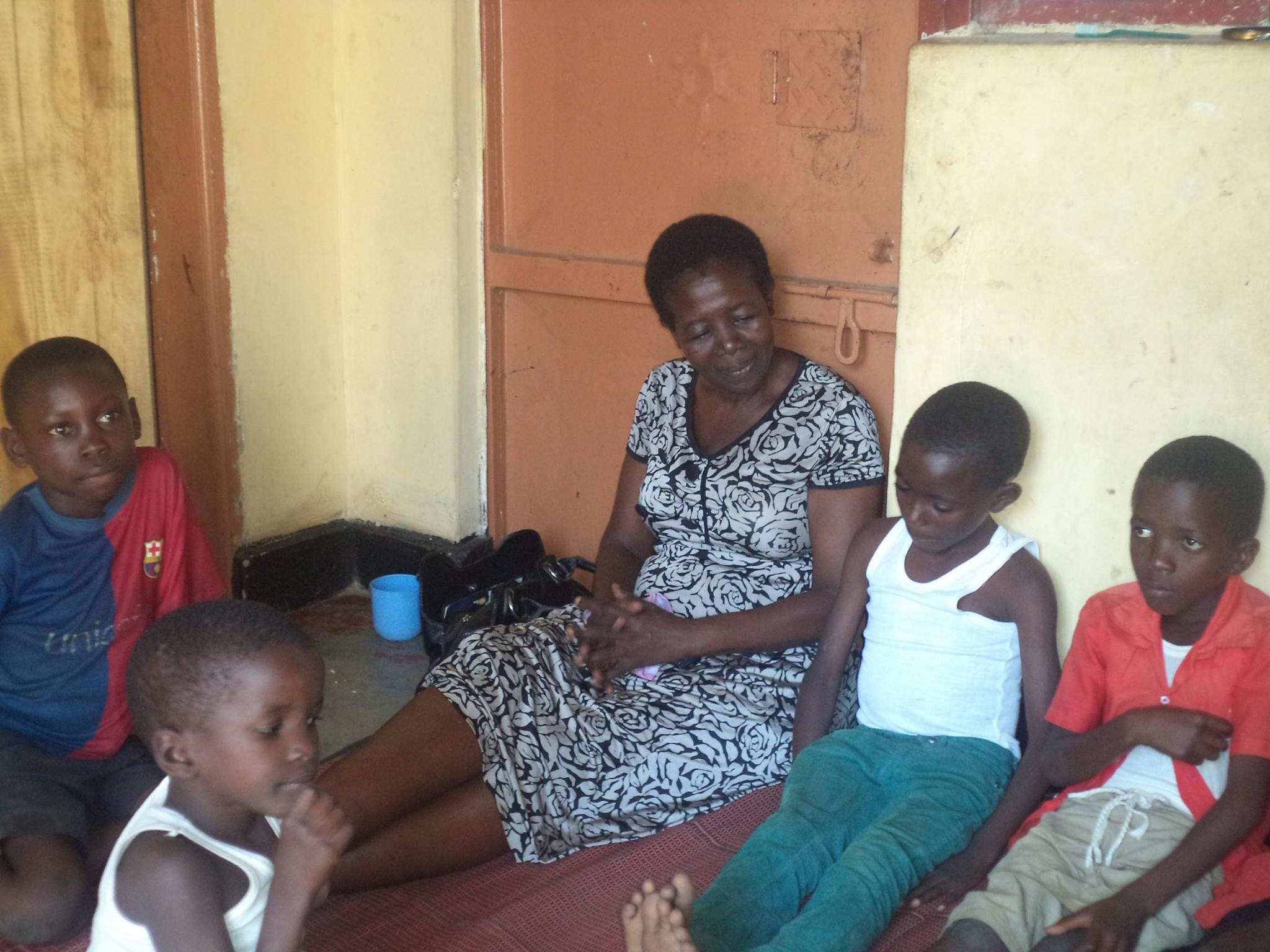 Martha and her children enjoying a snack and some down time at their home in Uganda.